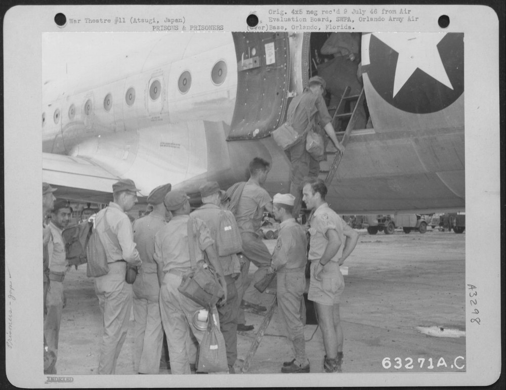 Crew Member of a Douglas C-54 Checks His Passenger List as Prisoners'