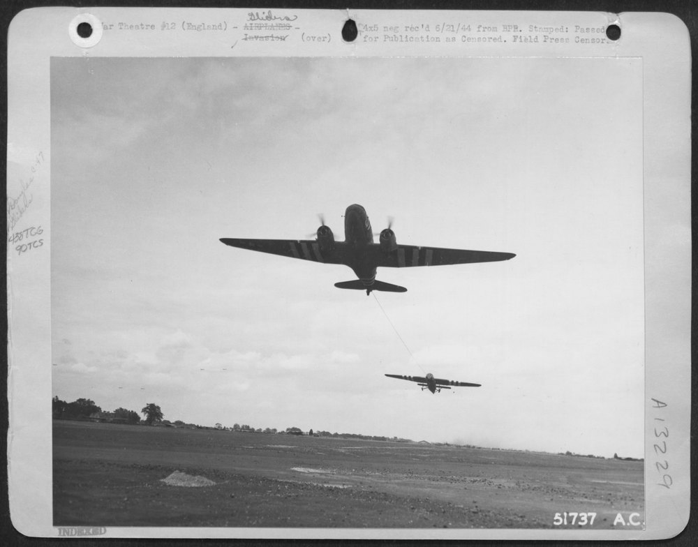 A Douglas C-47 transport is shown pulling a British built "Horsa"