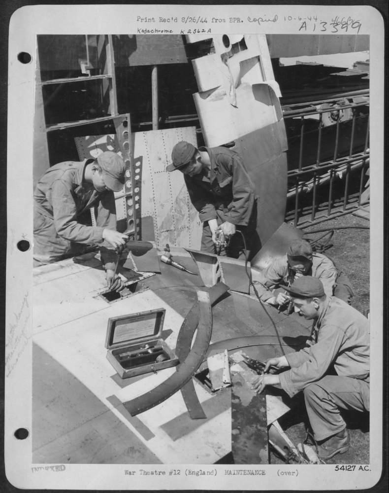 A flak punctured rudder is mended by these four members of the sheet