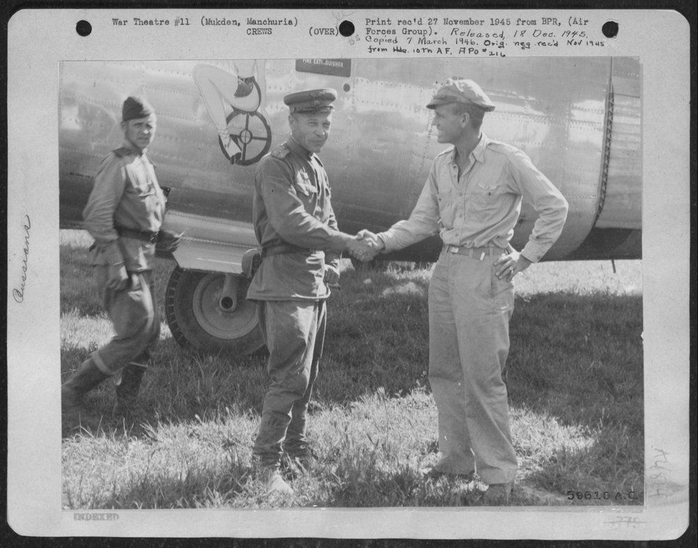 A pilot of the Red Air Force and a pilot of the Tenth Air Force shake