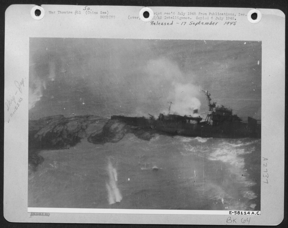 A Tell-Tale Oil Slick Spreads About The Smoldering Wreck After North