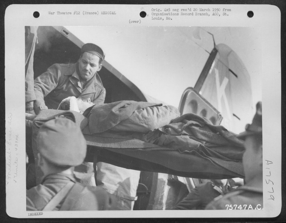 A Wounded Soldier Is Removed from a Douglas C-47 Evacuation Plane