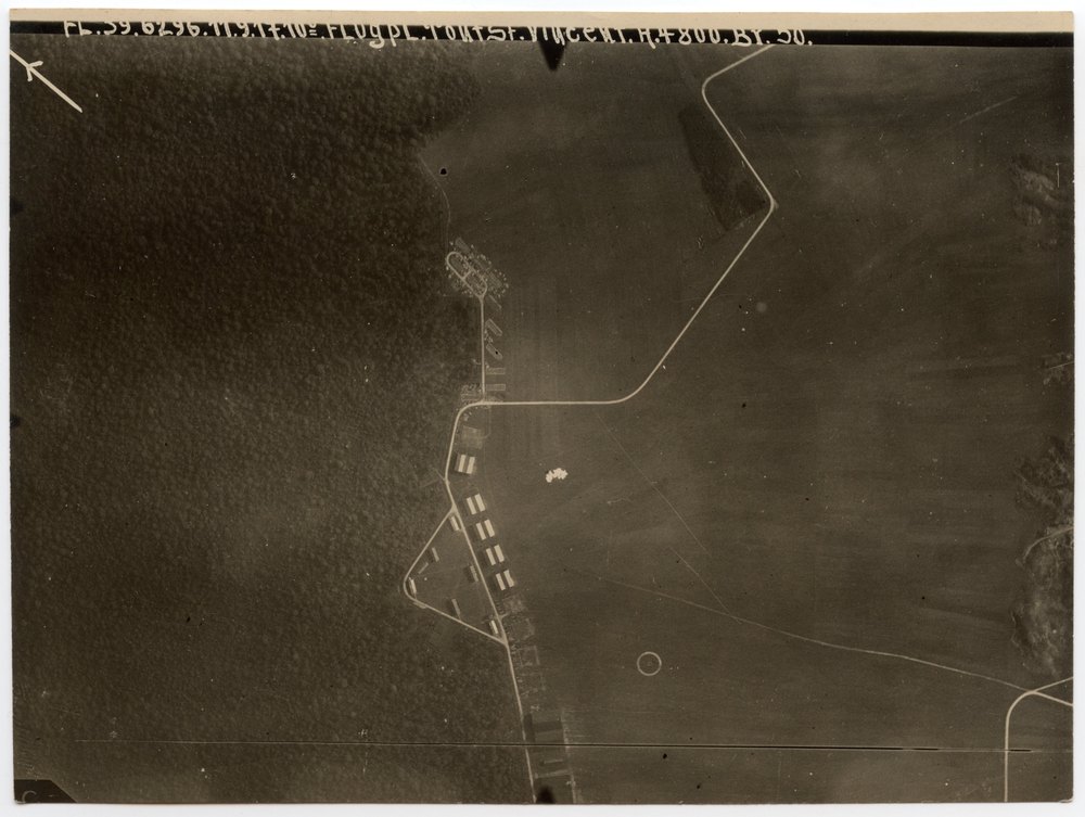 Aerial photograph of airfield with hangars and buildings