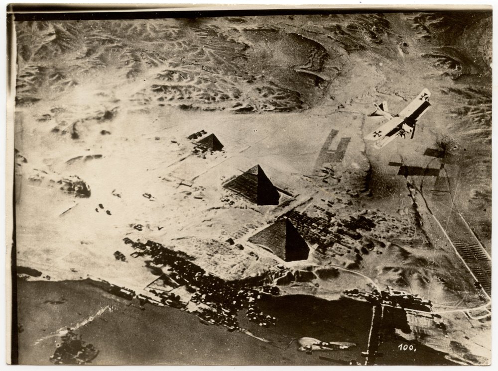 Aerial photograph of pyramids and biplane