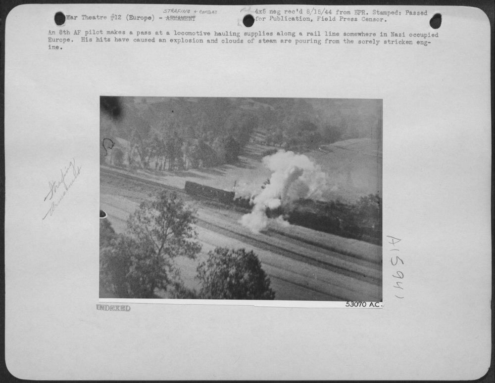 An 8th AF Pilot Makes a Pass at a Locomotive Hauling Supplies Along