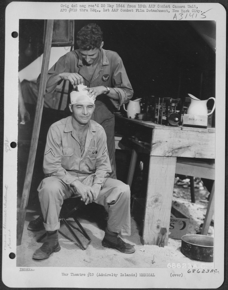 An attendant at a First Aid Station in the Admiralty Islands bandages