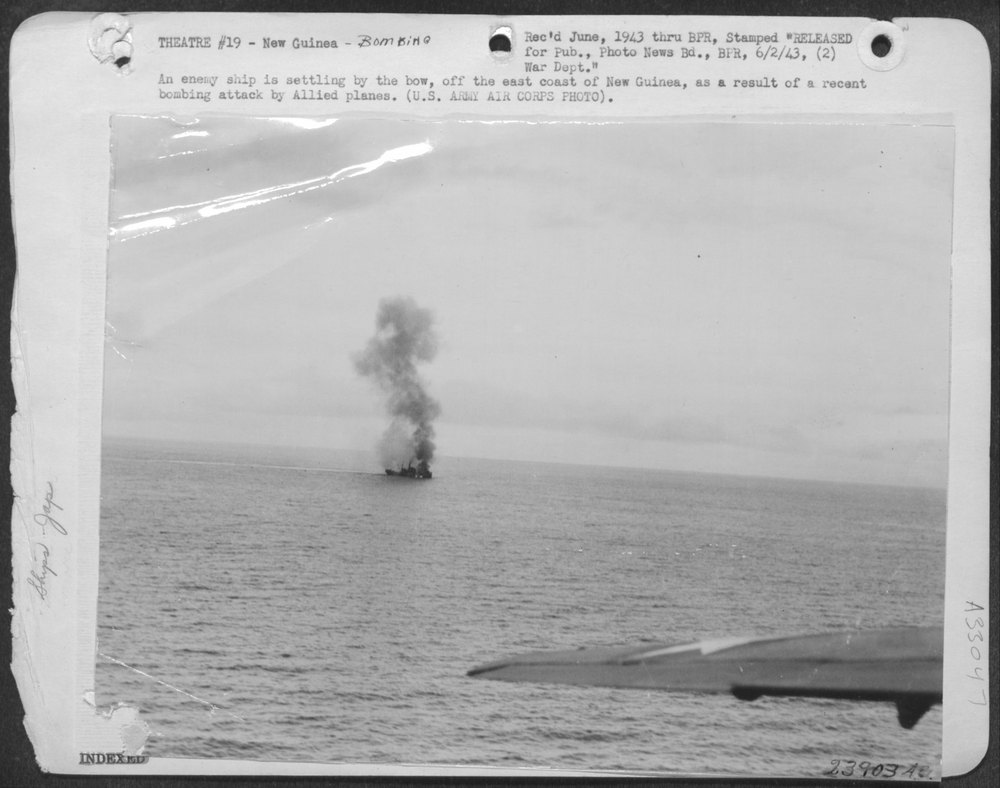 An enemy ship is settling by the bow, off the east coast of New