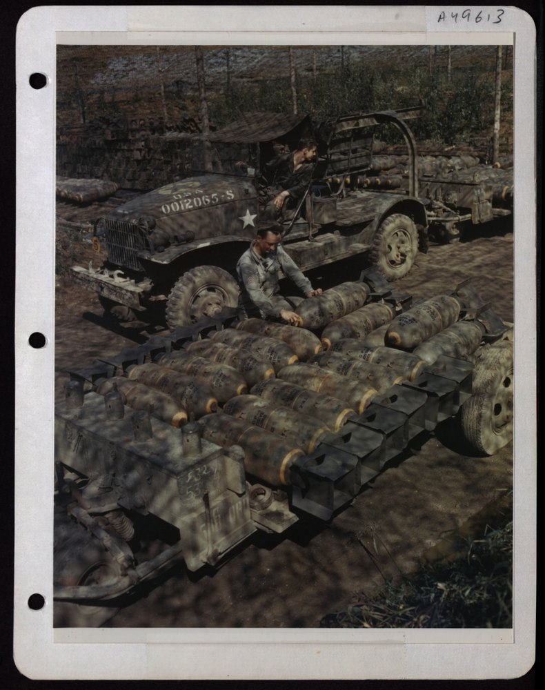 Armament men load bombs in England