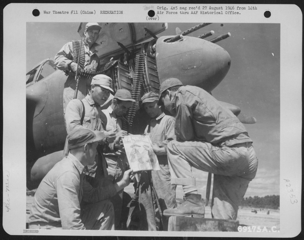 Armorers of the 14th Air Force in China and a Chinese Guard Take a Few