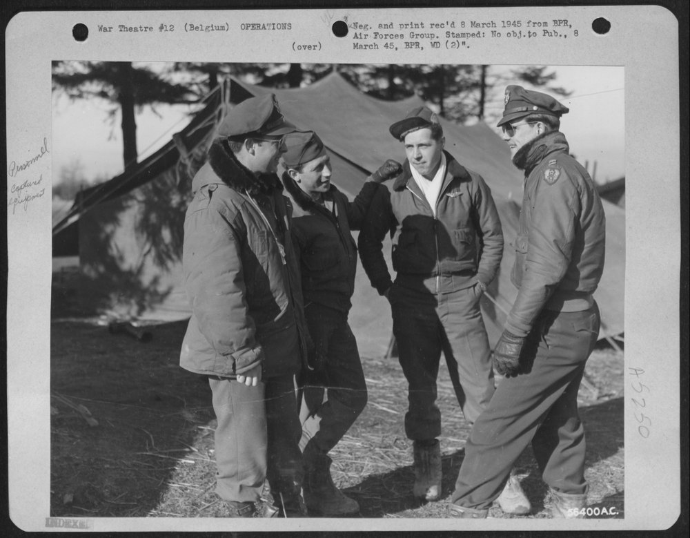 BELGIUM--talking over a mission in front of the captured german tents