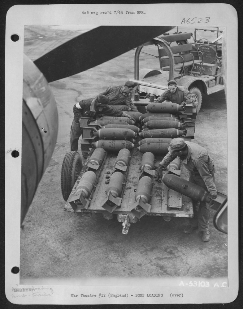 Bombs Are Being Loaded in a Boeing B-17 Flying Fortress to Help