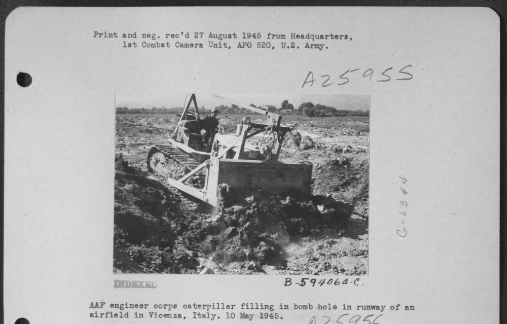 Catipillar filling bomb hole in Italy