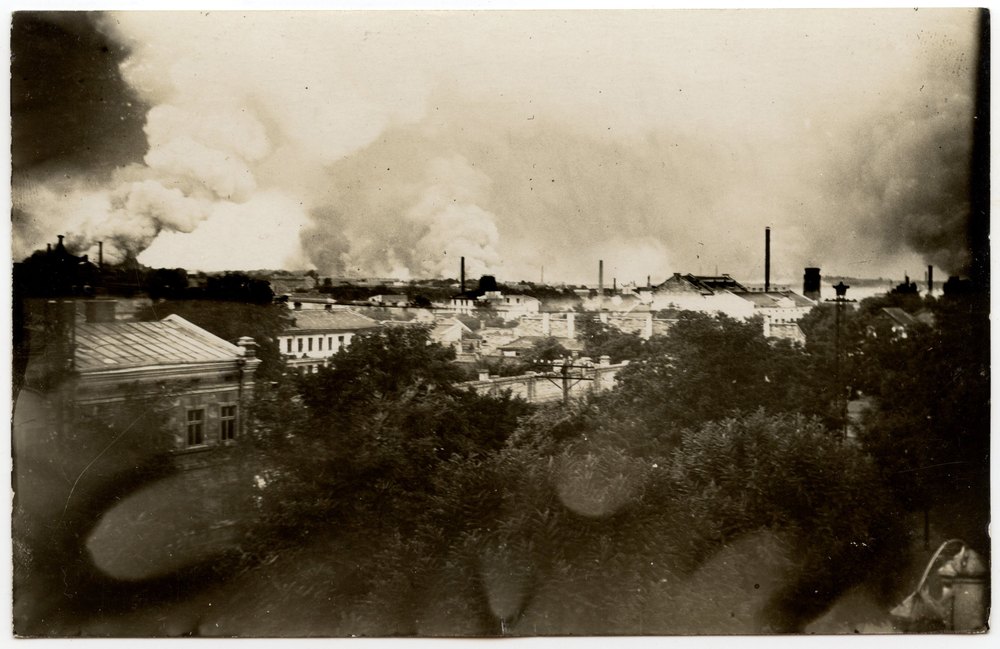 Cityscape with industrial structures and smoke