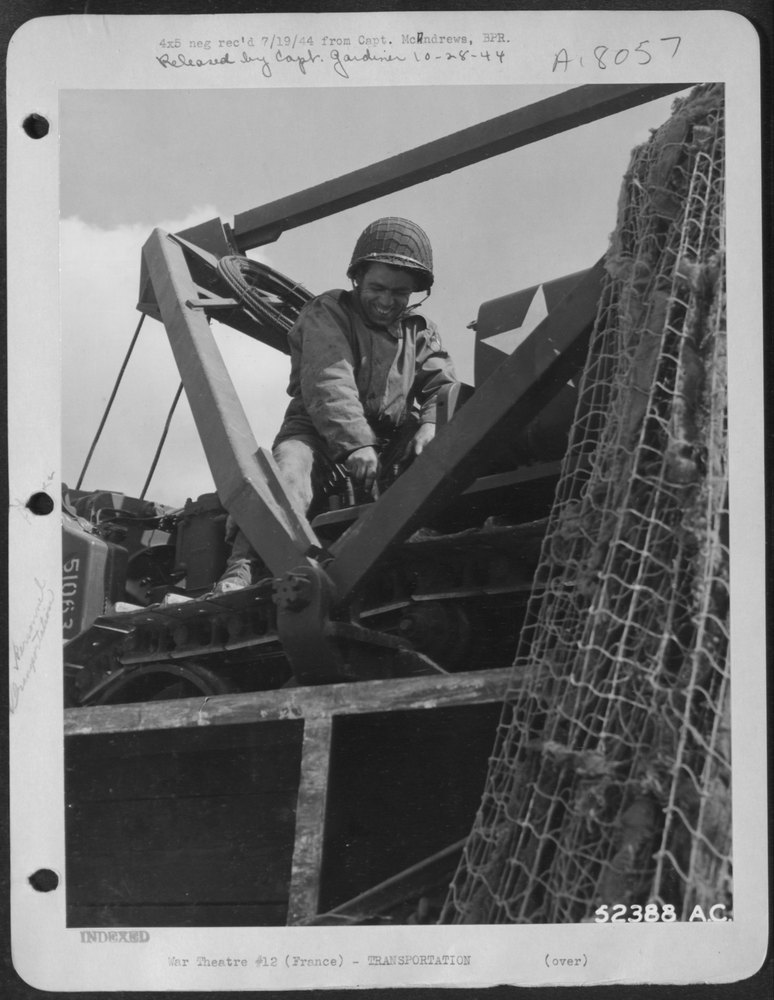 Cpl Harbrisri on bulldozer in truck