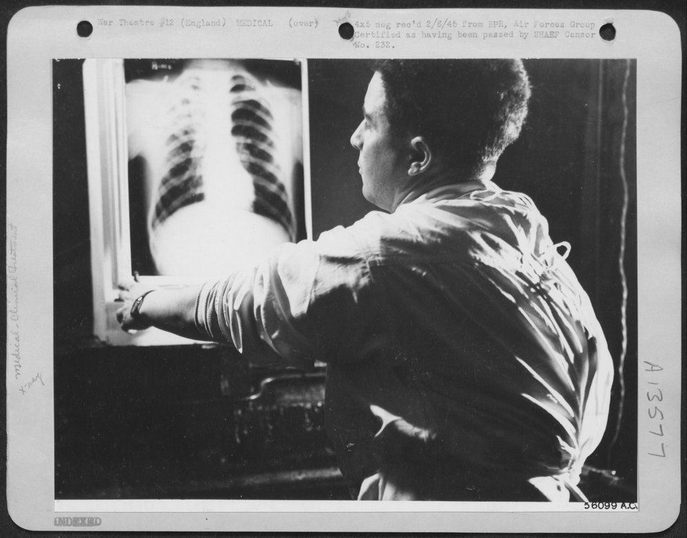Doctor inspects wounded man at hospital
