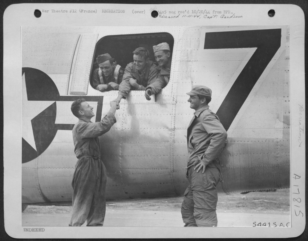 France-British G.I. Shakes Hands with American G.I. (in Plane)