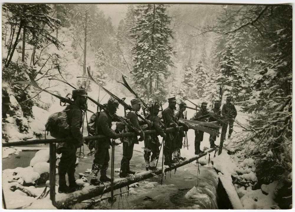German ski troops crossing a wooden bridge