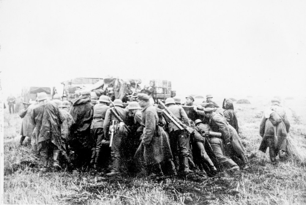 German soldiers push out bogged down vehicle