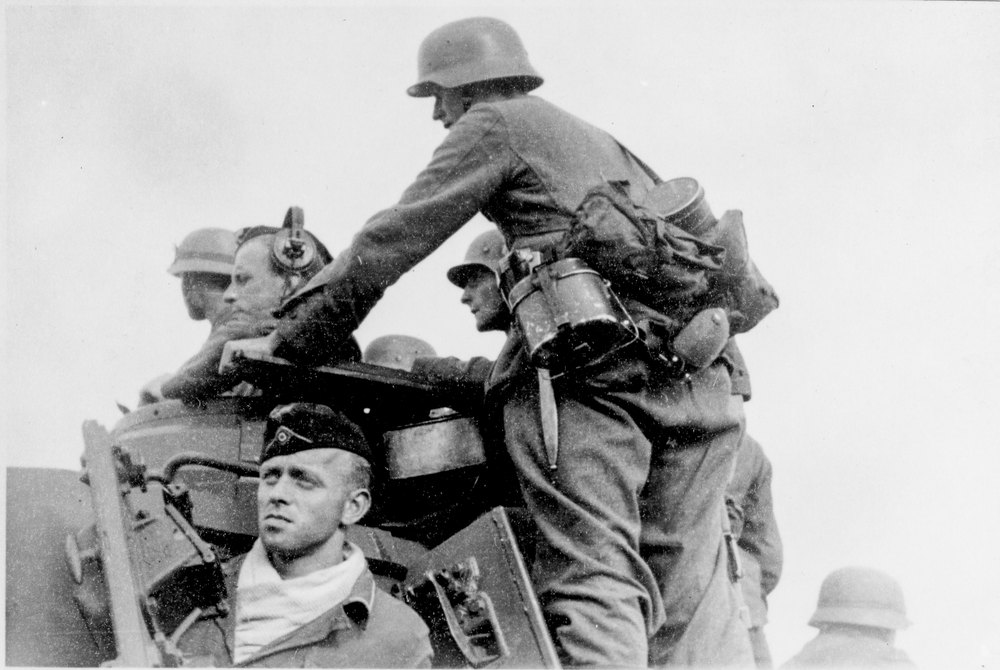 german troops riding on a tank