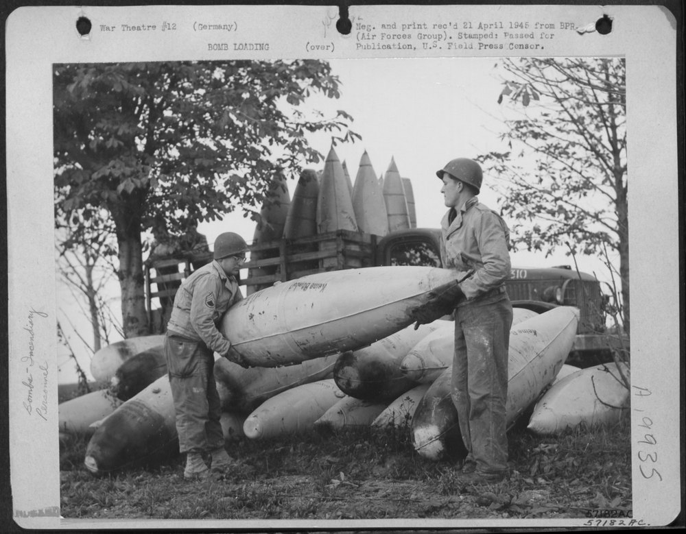 Ground Crewmen Unload Captured German Belly Tanks Preparatory