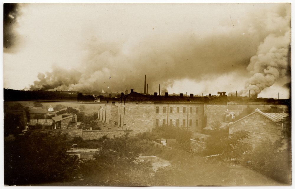 Industrial town with stone buildings and smokestacks
