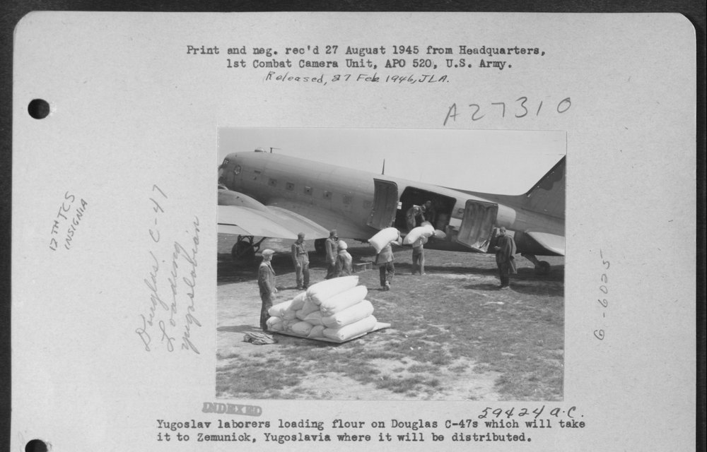 Laborers load flour onto C-47s in Yugoslavia