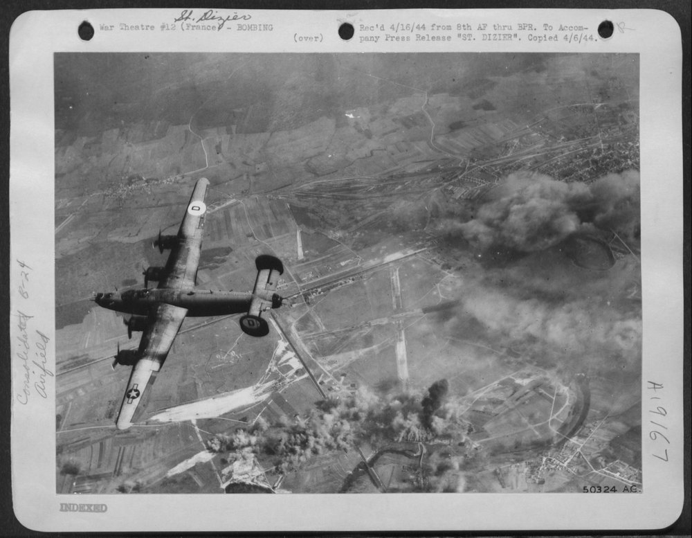 Liberator bomber over Nazi airfield