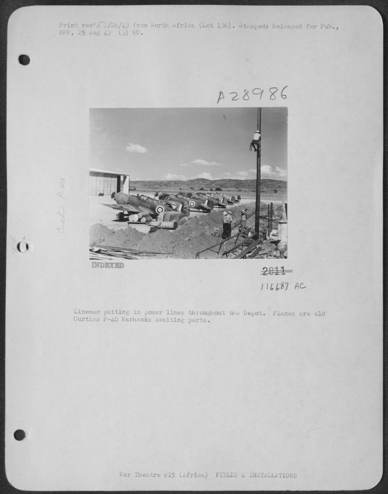 Linemen at depot with P-40 Warhawks