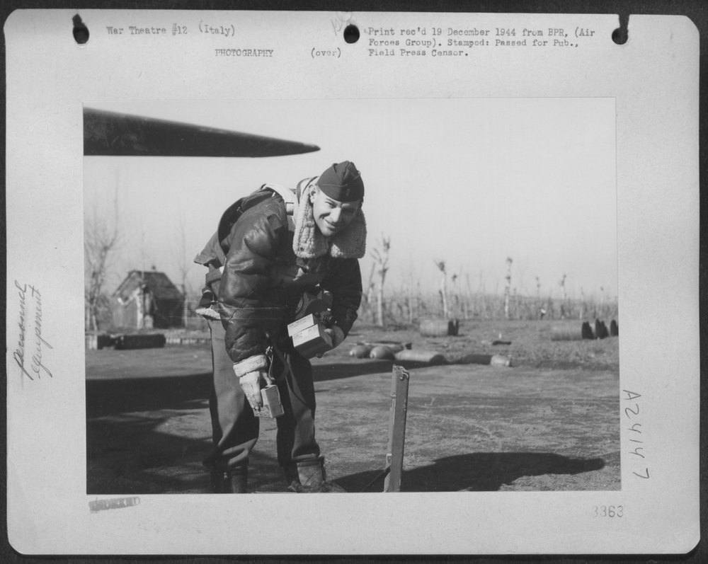 Lt Francis J Burgess loads camera Los Angeles