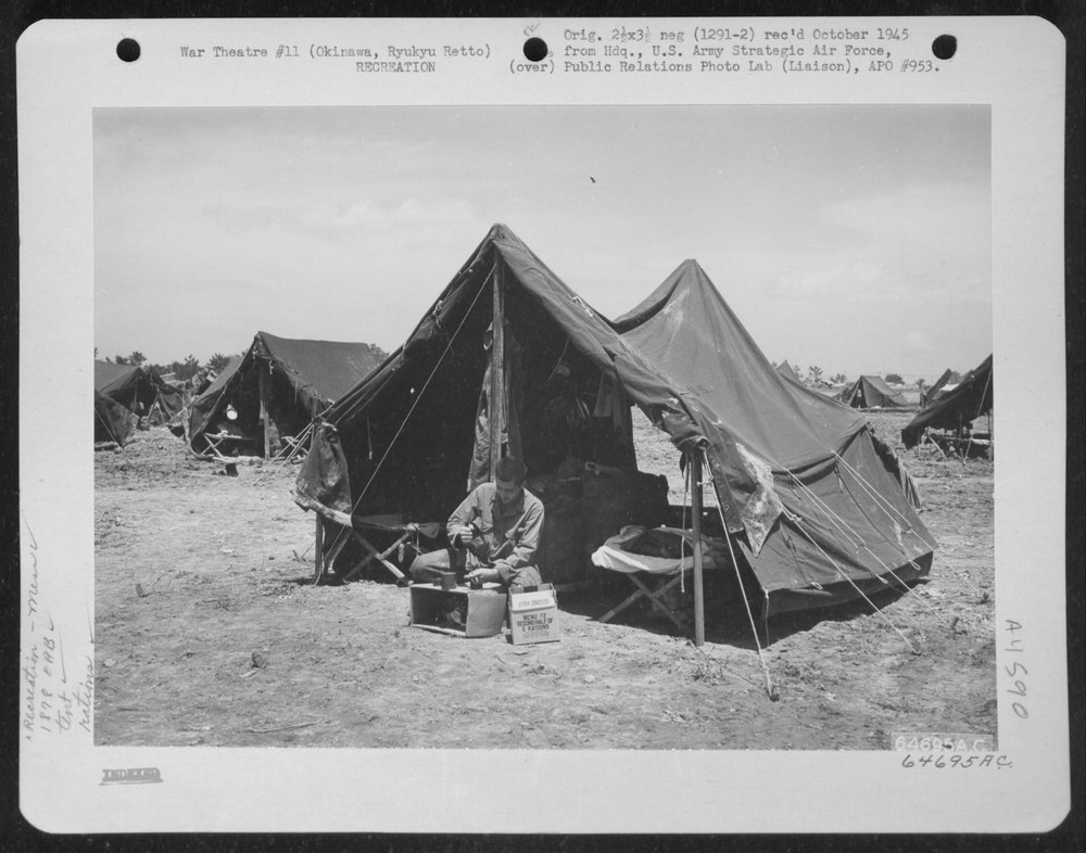 Man opens rations on Okinawa
