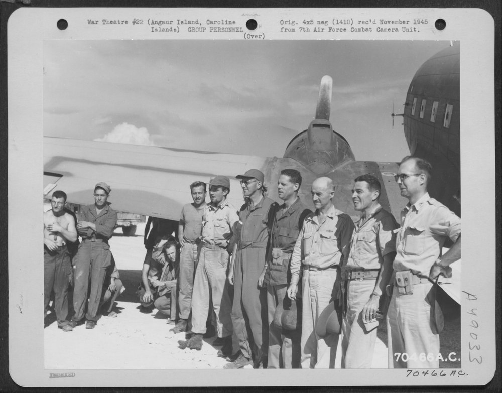 Men beside C-47 on Angaur Island