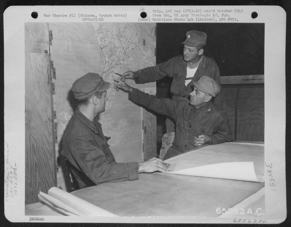 Men discuss airfield layout on Okinawa