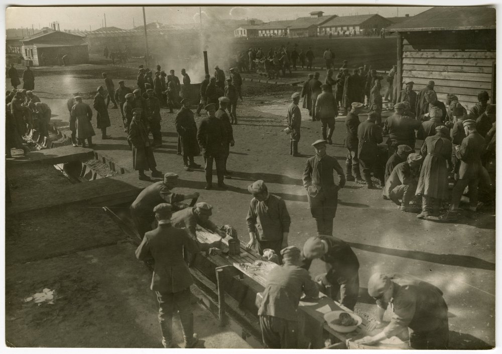 Men in military uniforms in a yard