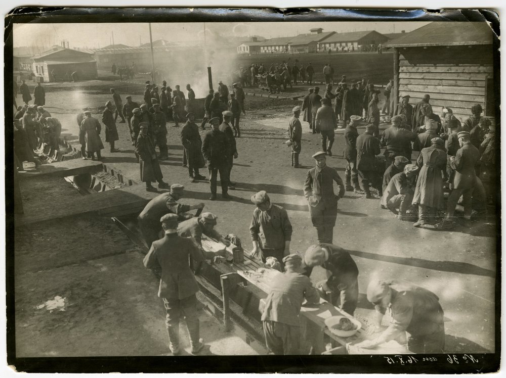 Men in uniforms in a military camp yard