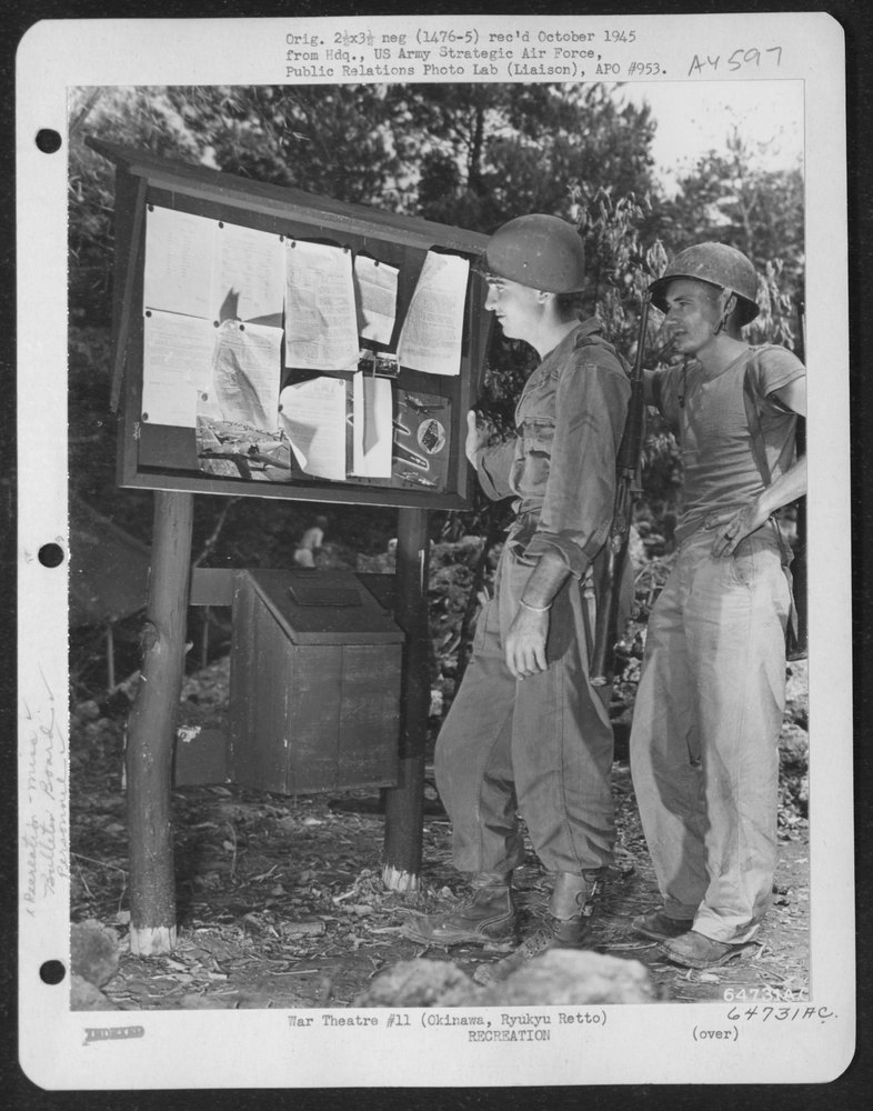 Men read news on Okinawa