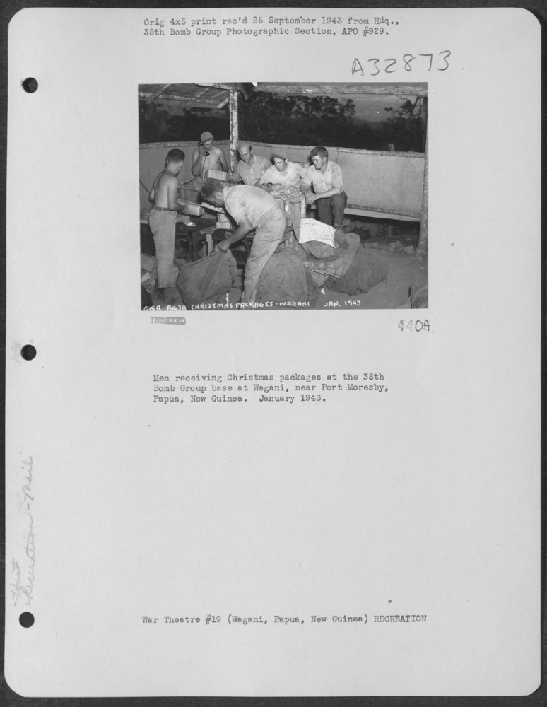 Men receive Christmas packages at 38th Bomb Group base