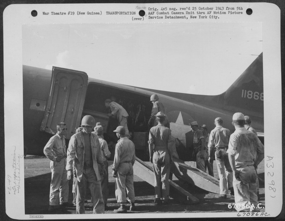 Men unloading supplies at Nadzab Airstrip