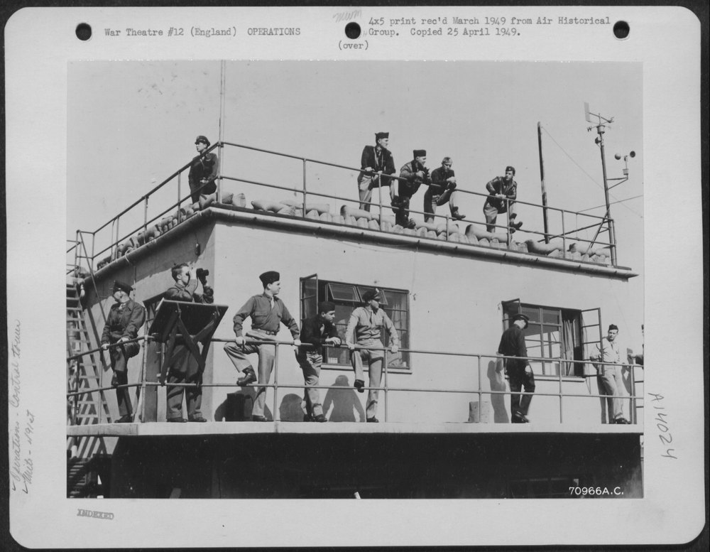 Men watch 491st Bomb Group planes return England