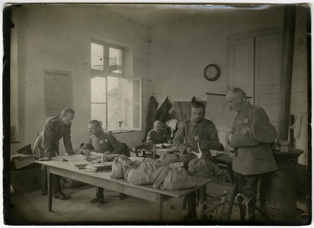 Military men in a room with papers and maps