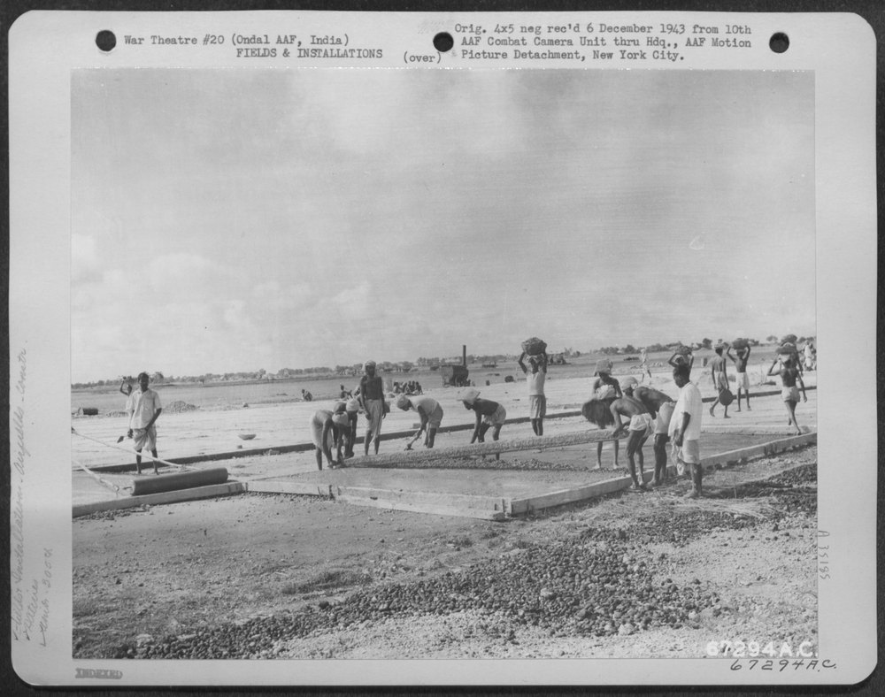 Natives lay concrete at Ondal Army Air Base