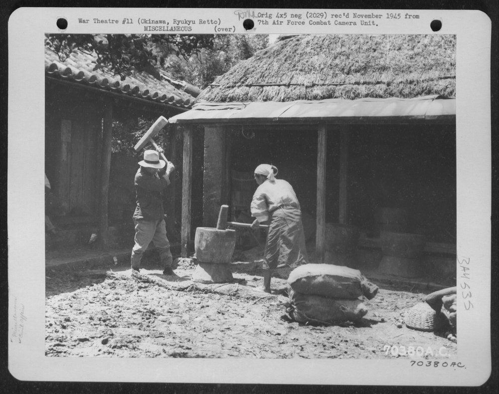 Natives pound rice on Okinawa