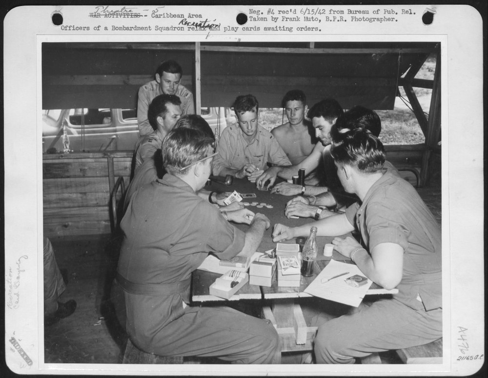 Officers of a Bombardment Squadron relax and play cards awaiting