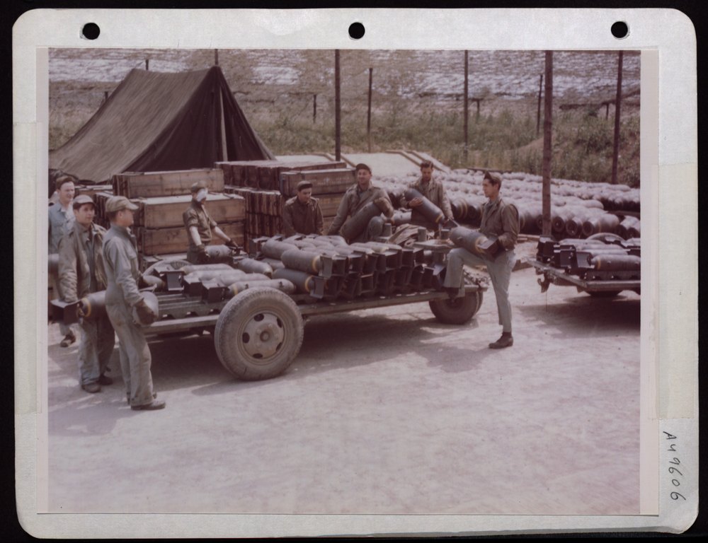 Ordnance men loading bombs in England
