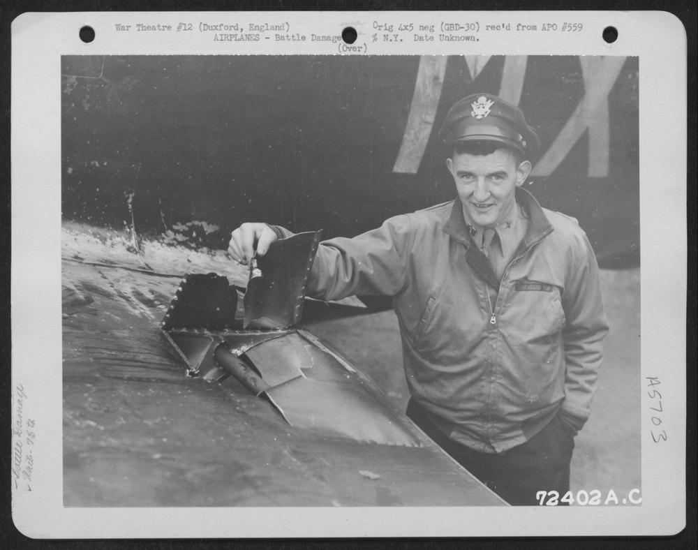 Pilot inspects P-47 at Duxford