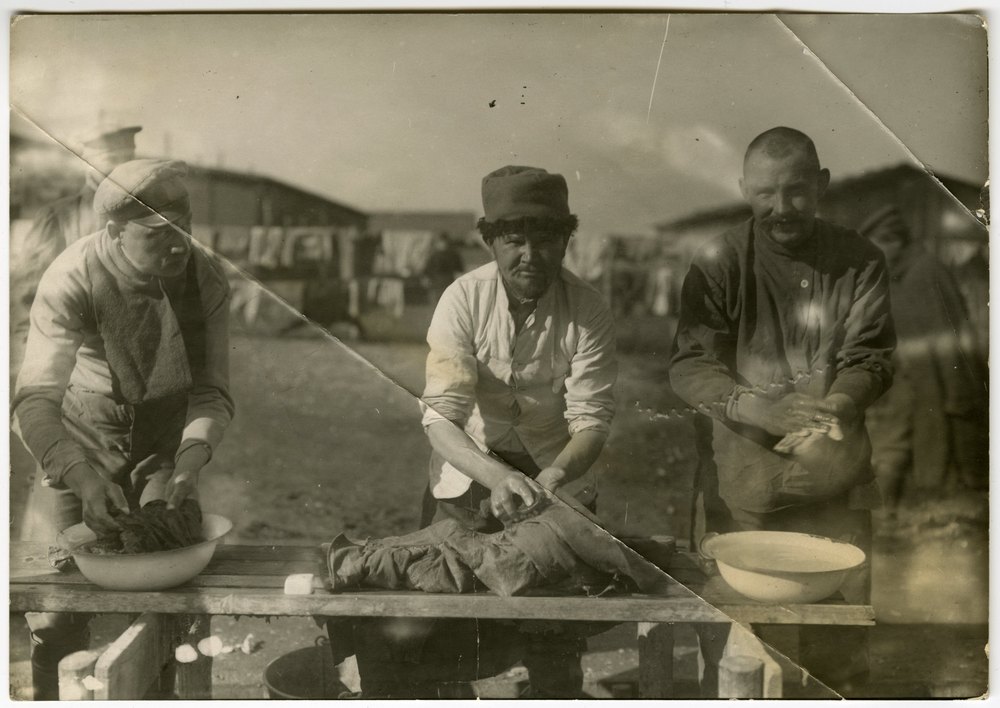 Prisoners preparing food outdoors