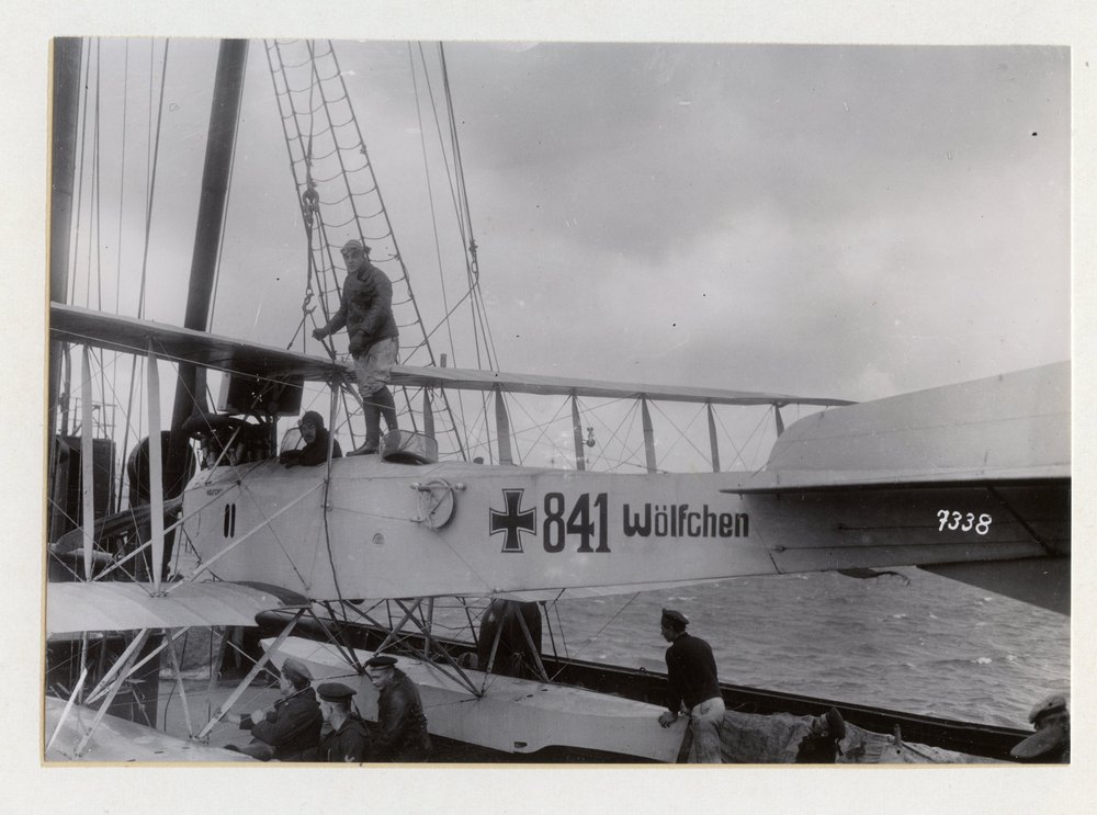 Return of the Wolf after a 15 month cruise. Taking the hydroplane Woelfchen off the deck. It rendered excellent reconnaissance service during the cruise of the Wolf