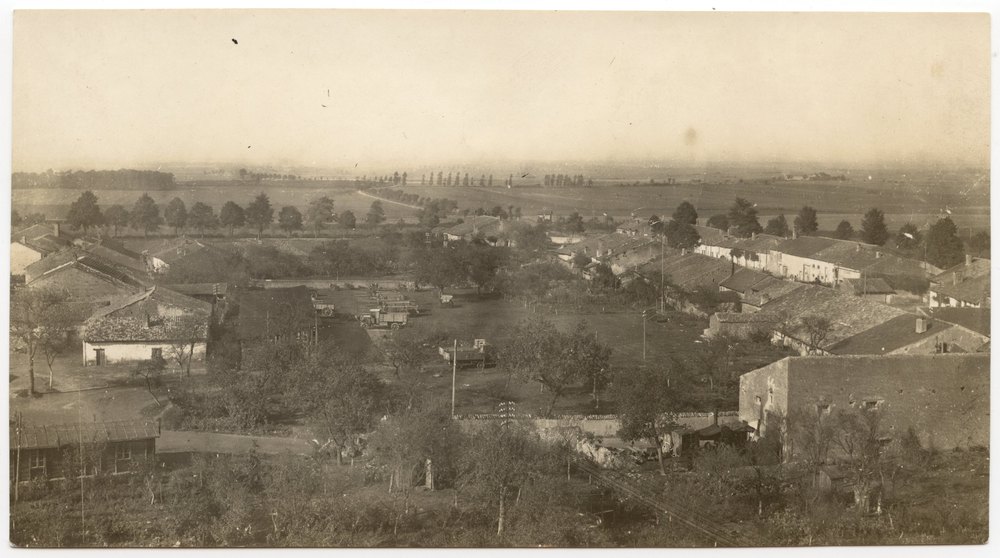 Rural settlement with motor vehicles and railway track