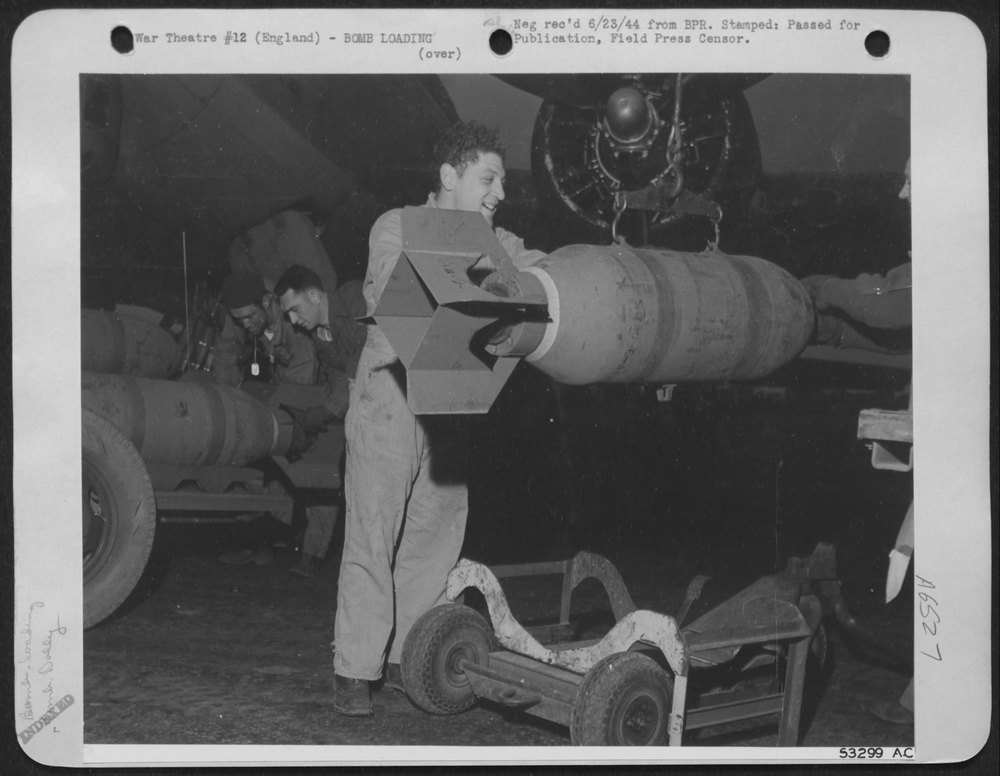 Shown is a jubilant armor crewman shoving a high explosive bomb away