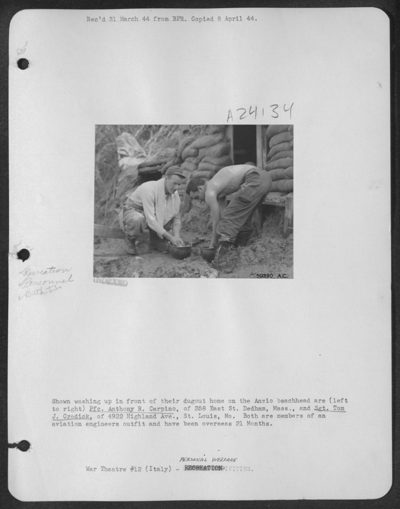 Shown washing up in front of their dugout home on the Anzio beachhead