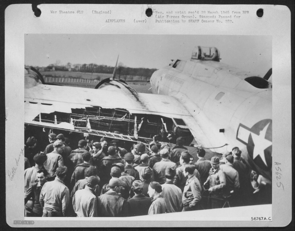 SLIGHT TEAR -- Men of a First Air Division Base View a Ripped Wing